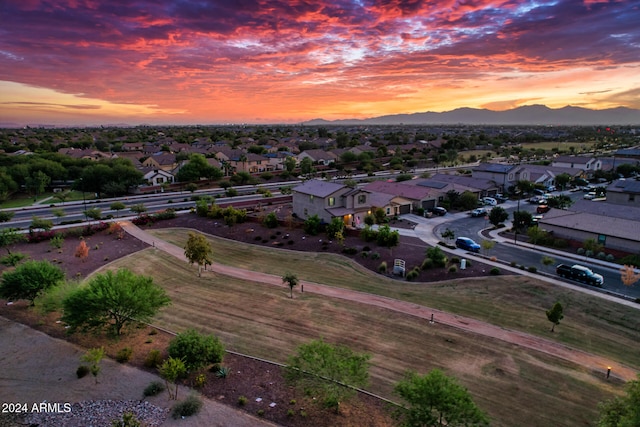 aerial view at dusk featuring a mountain view