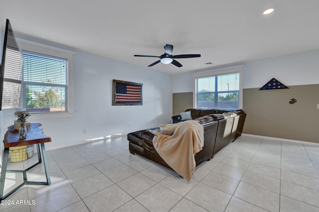 tiled living room featuring ceiling fan