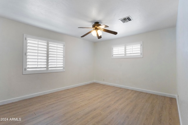 spare room with light wood-type flooring and ceiling fan