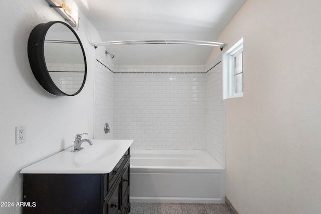 bathroom with tiled shower / bath combo and vanity