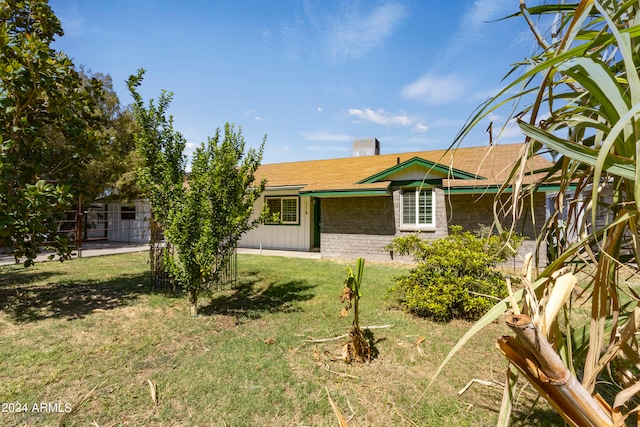 view of side of property with a lawn