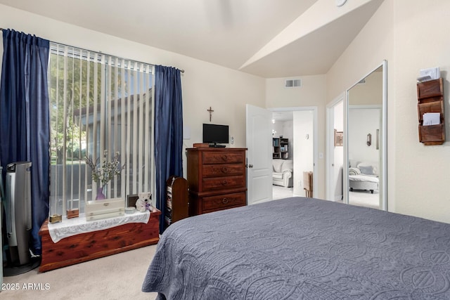 bedroom featuring light colored carpet and vaulted ceiling