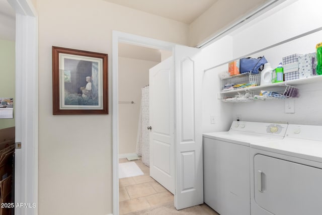 clothes washing area with light tile patterned floors and independent washer and dryer