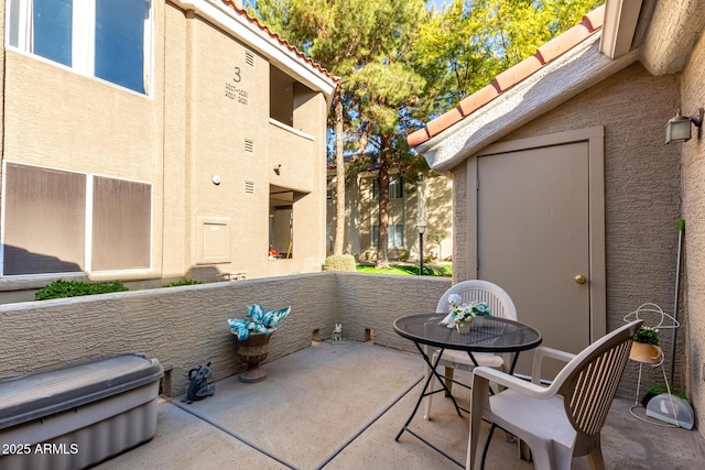 view of patio featuring a balcony