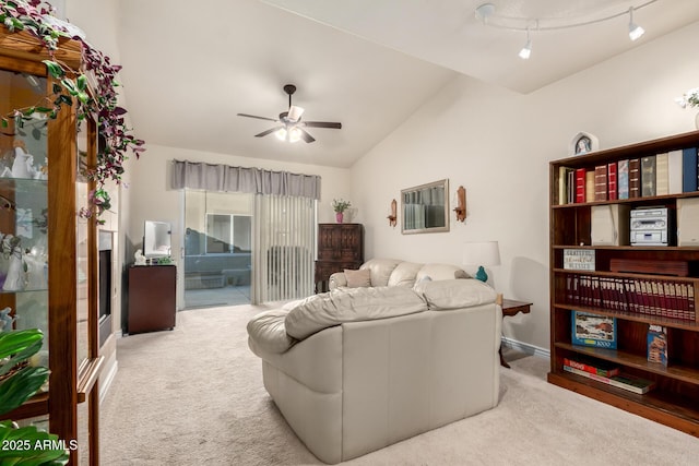 living room featuring ceiling fan, lofted ceiling, and light carpet