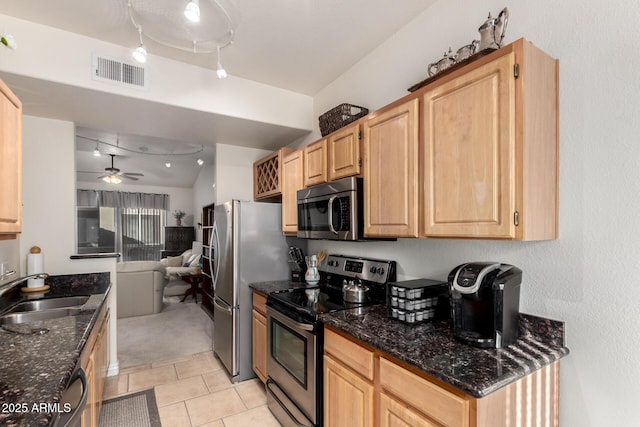 kitchen featuring ceiling fan, stainless steel appliances, light brown cabinets, and sink