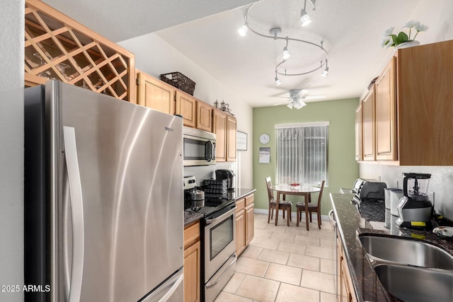 kitchen with appliances with stainless steel finishes, light brown cabinetry, sink, ceiling fan, and light tile patterned floors