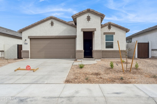 17806 W Vogel Ave, Waddell, AZ 85355 - view of front of house featuring a garage, driveway, stucco siding, and a tiled roof