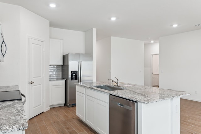 17806 W Vogel Ave, Waddell, AZ 85355 - kitchen with appliances with stainless steel finishes, a sink, light wood-type flooring, a center island with sink, and recessed lighting