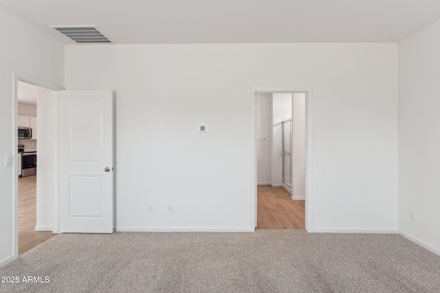 17806 W Vogel Ave, Waddell, AZ 85355 - unfurnished room with light carpet and baseboards