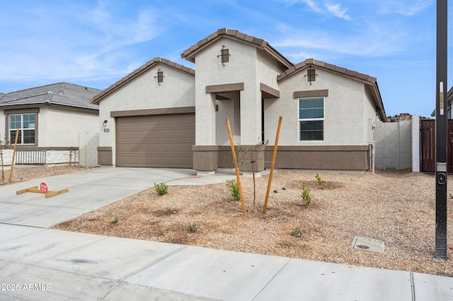 17806 W Vogel Ave, Waddell, AZ 85355 - view of front facade featuring a garage, driveway, stucco siding, and a tile roof