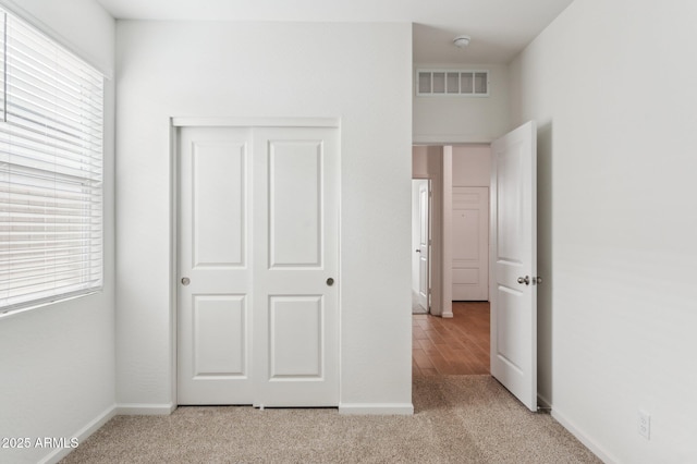 17806 W Vogel Ave, Waddell, AZ 85355 - unfurnished bedroom with carpet flooring, baseboards, and a closet