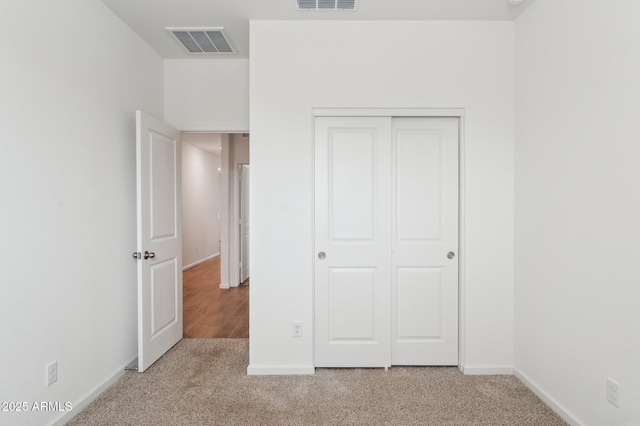 17806 W Vogel Ave, Waddell, AZ 85355 - unfurnished bedroom featuring light carpet, a closet, and baseboards