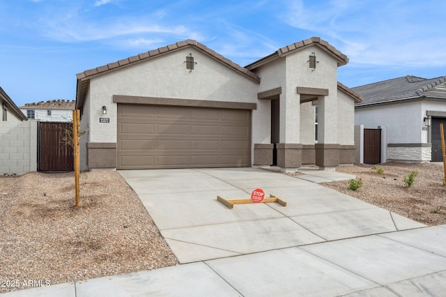 17806 W Vogel Ave, Waddell, AZ 85355 - view of front of home with concrete driveway, a garage, a gate, and stucco siding