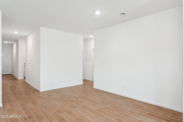 17806 W Vogel Ave, Waddell, AZ 85355 - empty room with light wood-style floors, recessed lighting, and baseboards