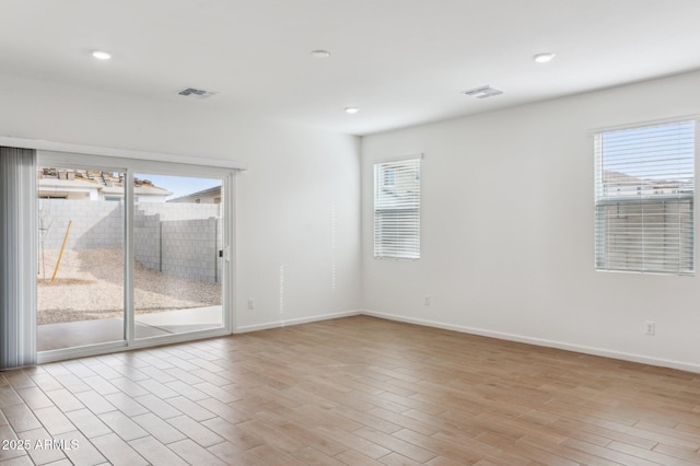 17806 W Vogel Ave, Waddell, AZ 85355 - empty room with healthy amount of natural light, light wood-type flooring, baseboards, and recessed lighting