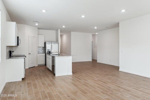17806 W Vogel Ave, Waddell, AZ 85355 - kitchen featuring open floor plan, stainless steel appliances, backsplash, recessed lighting, and light wood-style flooring