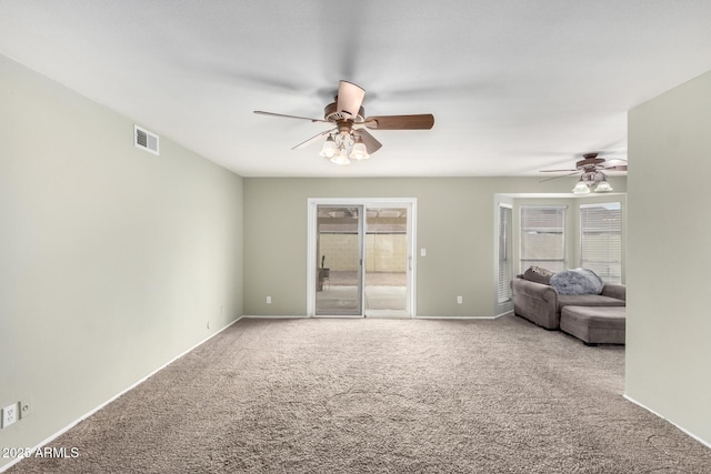 unfurnished living room featuring carpet floors and ceiling fan