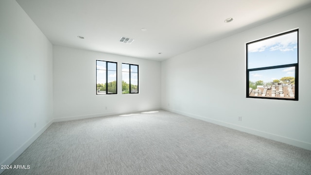 spare room with light colored carpet