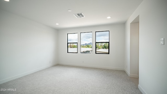 empty room featuring light colored carpet