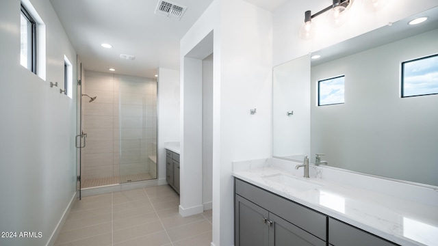 bathroom with tile patterned floors, vanity, and an enclosed shower