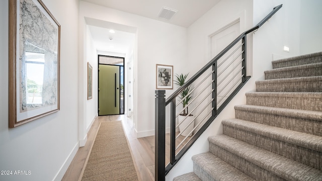 stairs featuring wood-type flooring