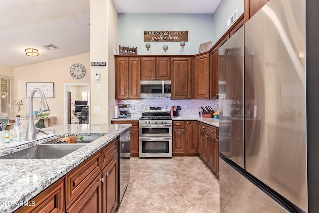 3823 E Kroll Dr, Gilbert, AZ 85234 - kitchen with appliances with stainless steel finishes, a sink, tasteful backsplash, light stone counters, and light tile patterned flooring