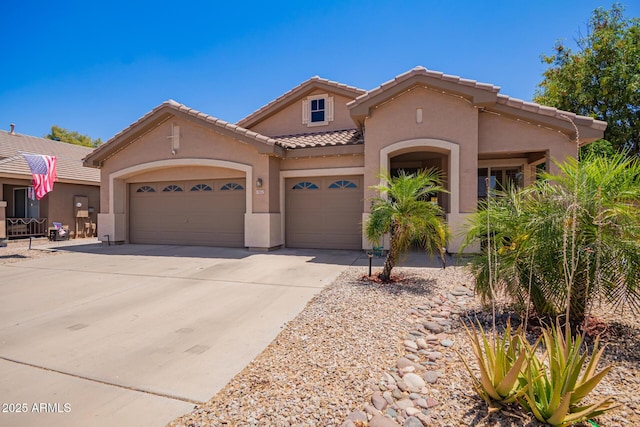 3823 E Kroll Dr, Gilbert, AZ 85234 - view of front of home featuring stucco siding, a tiled roof, a garage, and concrete driveway