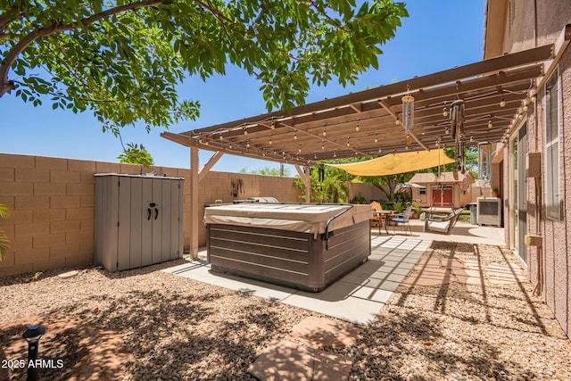 3823 E Kroll Dr, Gilbert, AZ 85234 - view of patio with a hot tub, a shed, a fenced backyard, a pergola, and an outdoor structure