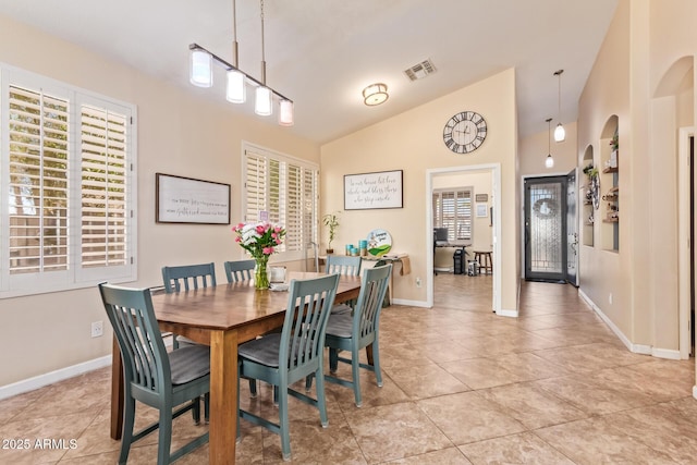3823 E Kroll Dr, Gilbert, AZ 85234 - dining area featuring light tile patterned floors, baseboards, vaulted ceiling, and arched walkways