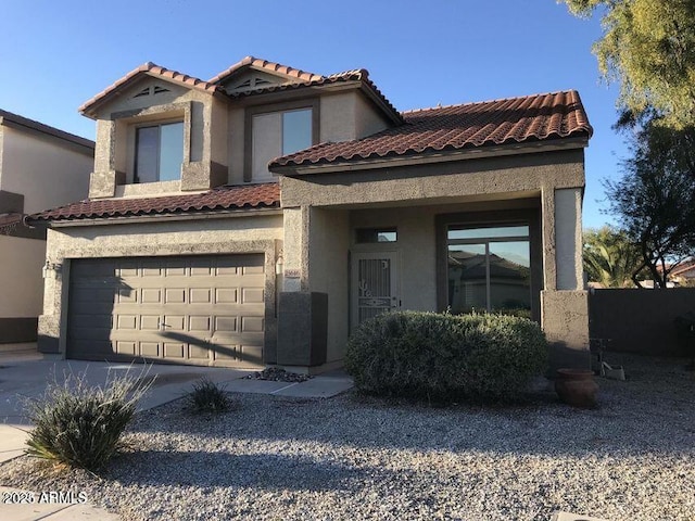 view of front facade featuring a garage, concrete driveway, a tiled roof, and stucco siding