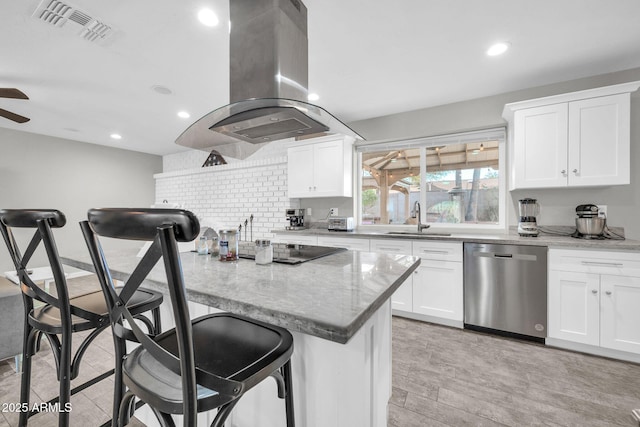 kitchen with a kitchen bar, white cabinetry, island exhaust hood, sink, and stainless steel dishwasher