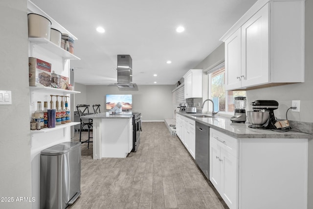 kitchen featuring appliances with stainless steel finishes, white cabinetry, sink, island range hood, and a breakfast bar