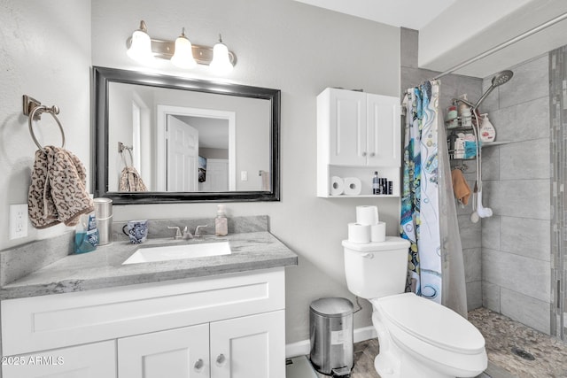 bathroom with vanity, toilet, and walk in shower