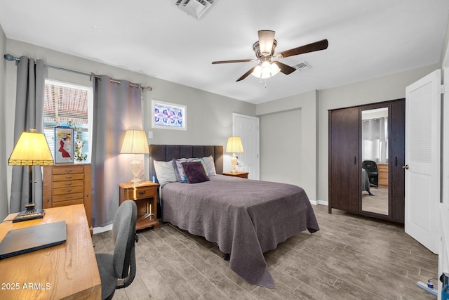 bedroom with wood-type flooring and ceiling fan