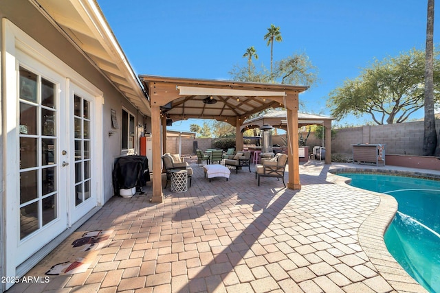 view of swimming pool with a patio, french doors, ceiling fan, a gazebo, and grilling area