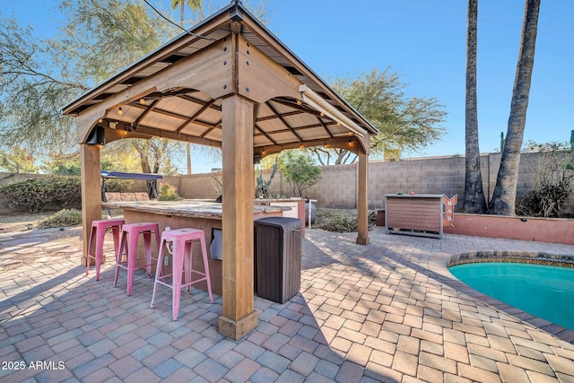 view of patio with a gazebo and an outdoor bar