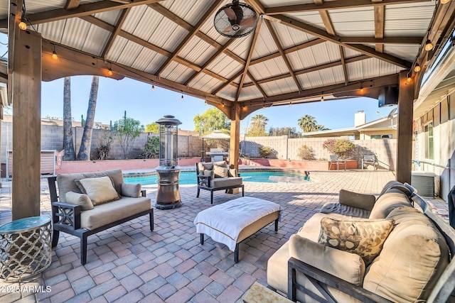 view of patio featuring an outdoor living space, a fenced in pool, and a gazebo