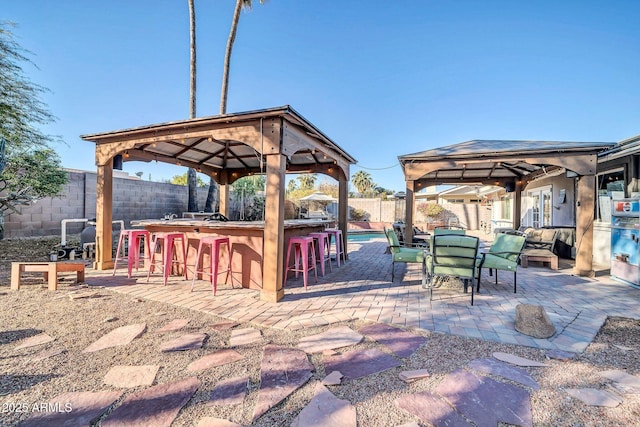 view of patio featuring a gazebo and exterior bar