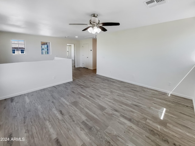 unfurnished room featuring ceiling fan and hardwood / wood-style floors