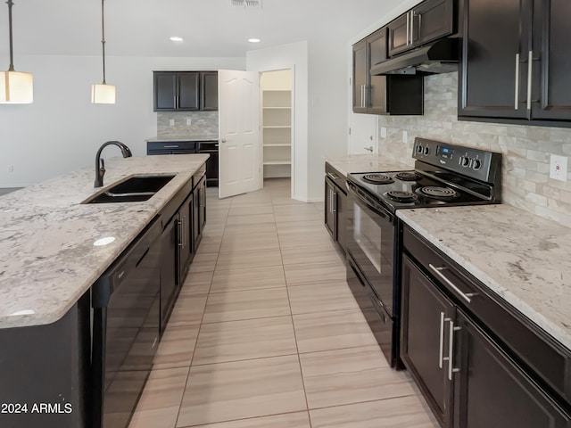 kitchen with tasteful backsplash, black appliances, sink, light tile floors, and pendant lighting