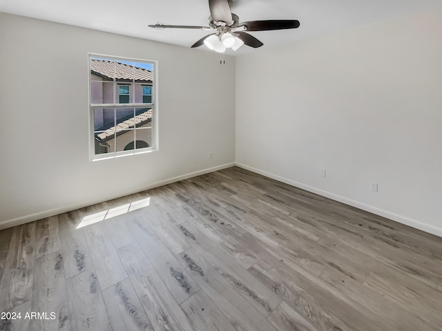 spare room with wood-type flooring and ceiling fan