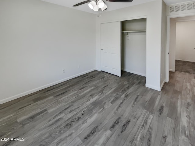 unfurnished bedroom featuring wood-type flooring, a closet, and ceiling fan