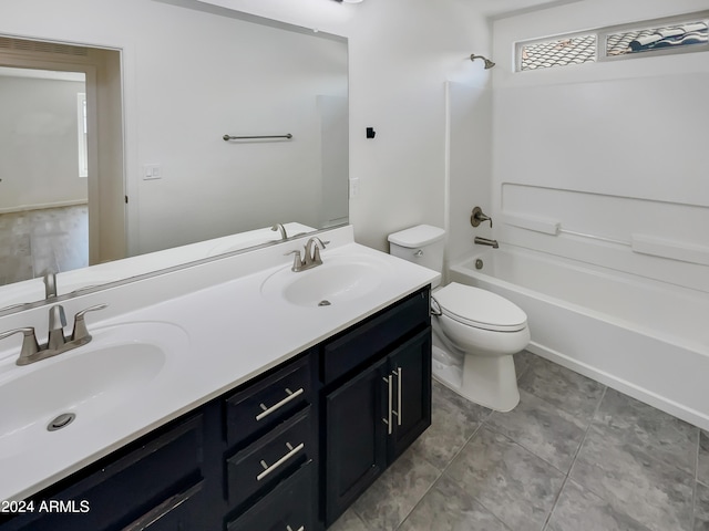 full bathroom with tile floors, double sink vanity, toilet, and tub / shower combination