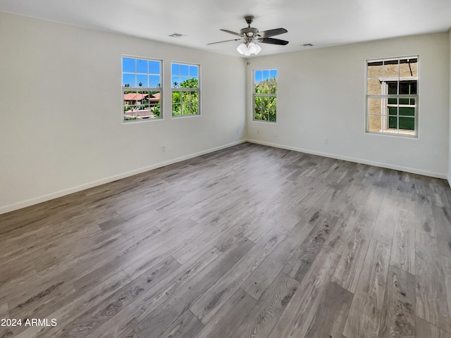 unfurnished room with ceiling fan and hardwood / wood-style floors