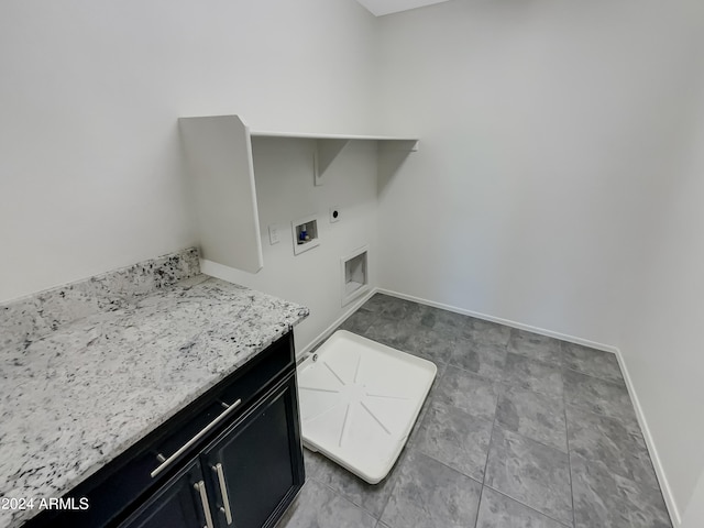 laundry room with light tile floors, cabinets, hookup for a washing machine, and electric dryer hookup