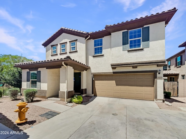 mediterranean / spanish home featuring a garage