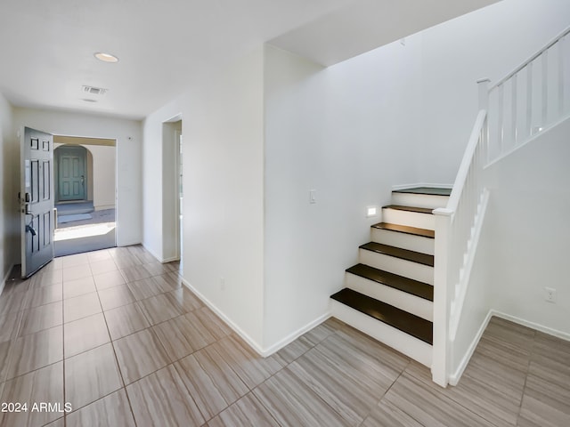 staircase with light tile floors