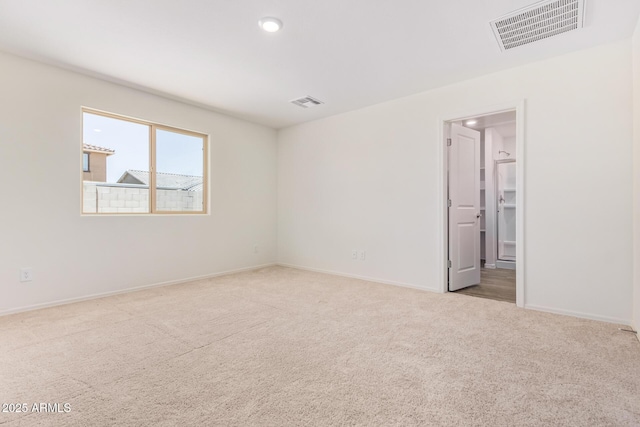 unfurnished room with light carpet