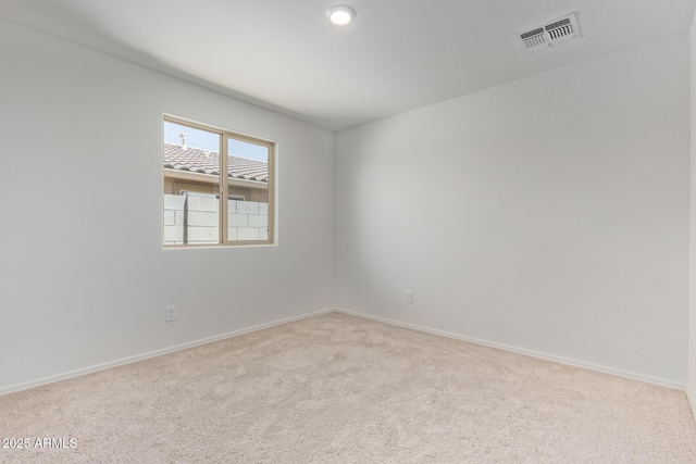 empty room with light colored carpet